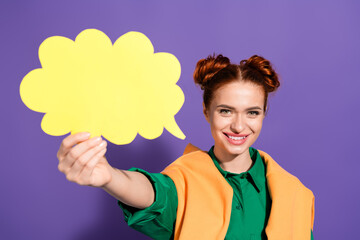 Young woman holding a yellow thought bubble with a cheerful expression against a vibrant purple background