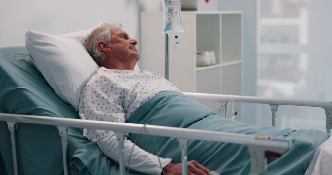 Bed, IV drip and senior man in hospital for treatment, healing or surgery recovery with liquid medication. Relax, health insurance and elderly male patient in ward for medical care at clinic.