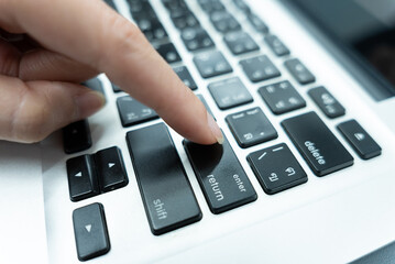 Asian woman typing on keyboard and hands typing on laptop on finance analysis and statistics topics. Organizational concept in office.