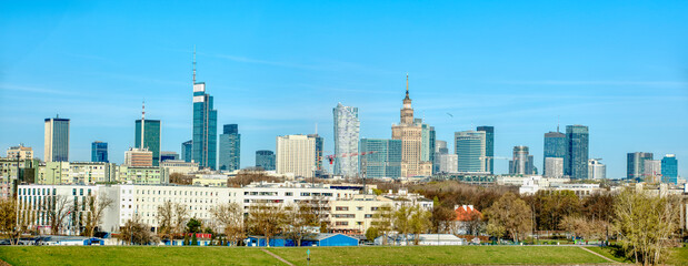 Panoramic view of Warsaw's skyline with modern and historic buildings.