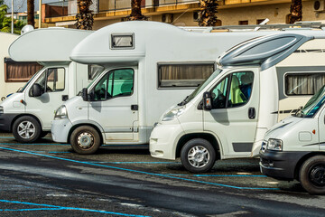 campers and motorhomes on asphatl parning, white auto caravan for  vacation travel