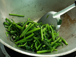 stir frying water spinach or morning glory