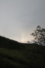 rainbow on a hill after rain