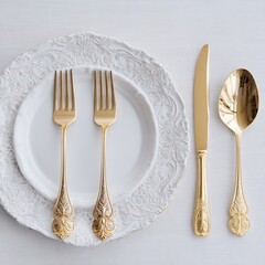 Elegant gold cutlery set on white plate stock photo for dining table setting and silverware collection