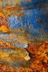 Rusty metal surface with shabby background paint. Blue cracked paint texture on an iron sheet. Fragment of an old metal door, Metal corrosion.