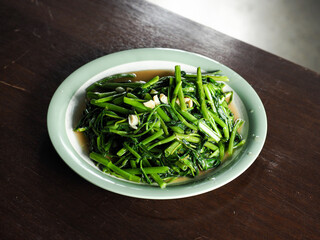 dish of stir fried water spinach or morning glory with garlic