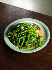 dish of stir fried water spinach or morning glory with garlic