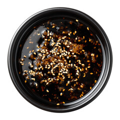 ginger soy sauce with sesame in black bowl top view isolated