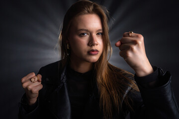 Portrait of a determined woman in leather jacket showing strength