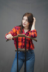 Obraz na płótnie Canvas Stylish Woman in Casual Denim and Plaid Crop Top – Studio Fashion Portrait