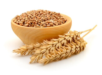 Wheat grains in wooden bowl and ears