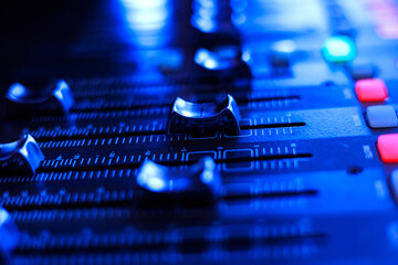 Concert sound mixer panel with volume regulators. Professional audio and light equipment for sound...