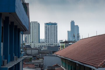 Urban Skyline with Buildings and Rooftops Under a Cloudy Sky