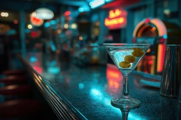 Martini glass and olives shimmer under neon lights in late-night diner