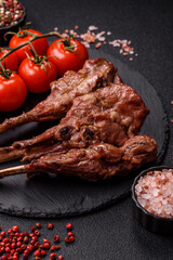 Juicy meat on the bone or rack of lamb. Grilled veal with salt, spices and herbs