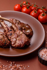 Juicy meat on the bone or rack of lamb. Grilled veal with salt, spices and herbs