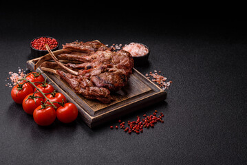 Juicy meat on the bone or rack of lamb. Grilled veal with salt, spices and herbs