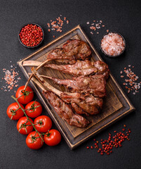 Juicy meat on the bone or rack of lamb. Grilled veal with salt, spices and herbs