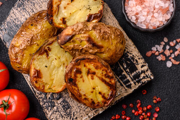 Food, potatoes cut in halves or slices grilled. Cooked baked potatoes