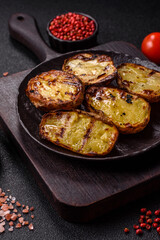 Food, potatoes cut in halves or slices grilled. Cooked baked potatoes