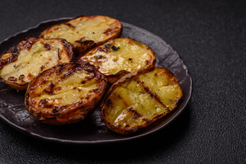 Food, potatoes cut in halves or slices grilled. Cooked baked potatoes