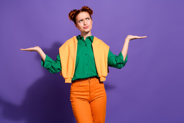 Adorable red haired woman in colorful casual attire gesturing against a vibrant violet background