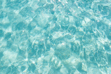 Sunlit turquoise water surface with gentle waves