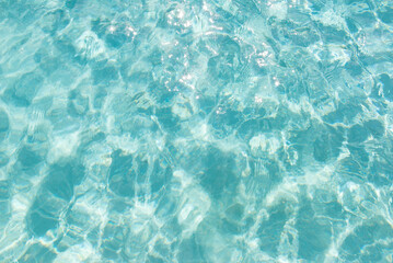 Sunlit turquoise water surface with gentle waves