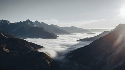 Misty mountain valley draped in clouds during early morning light revealing the beauty of nature's landscape