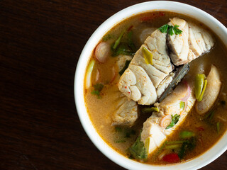 top view Thai spicy Tom Yum soup with seabass fillet