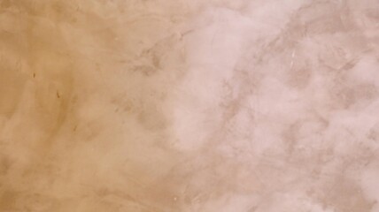 a close up view of an elegant textured marble wall surface with a subtle, warm beige tone.
