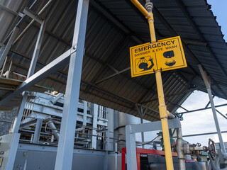 Yellow emergency shower and eye wash sign in the chemical industry area. Wash the part that is...