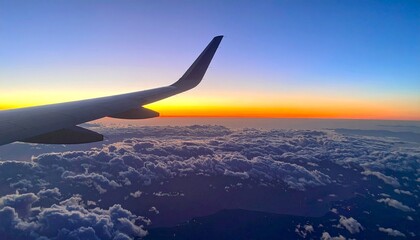 Obraz premium Plane wing viewed from inside cabin during sunset
