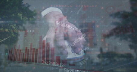 Image of numbers and graph over hand of caucasian man holding mouse and cityscape