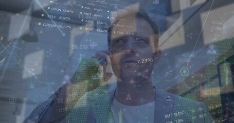 Image of data processing over caucasian businessman talking on smartphone