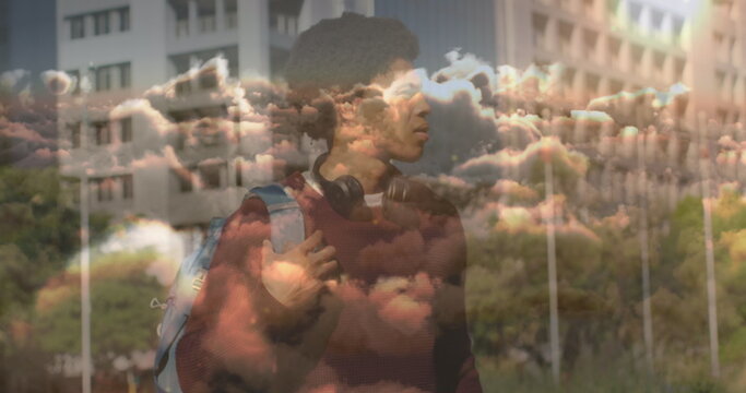 Image of clouds over african american businessman - Powered by Adobe