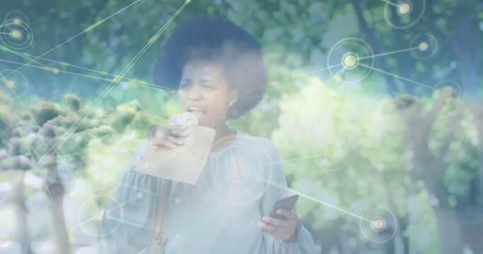 Image of clouds over african american businesswoman walking