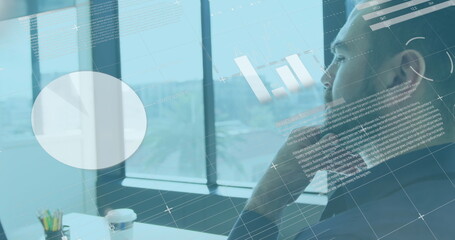 Image of financial graphs and data over caucasian man using laptop