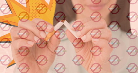 Image of rows of lit cigarettes with no smoking signs over woman breaking cigarette