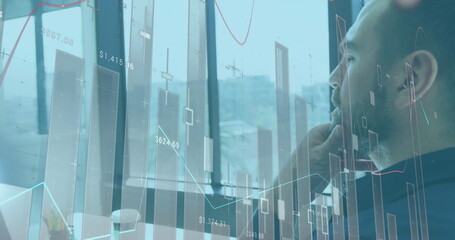 Image of financial graphs and data over caucasian man in office