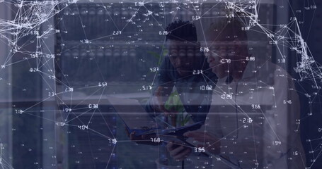 Image of network of connections and icons over two diverse business people