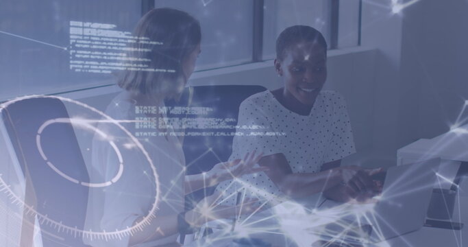 Collaborating mid adult women debugging code at office desk, with laptops and network graphics - Powered by Adobe