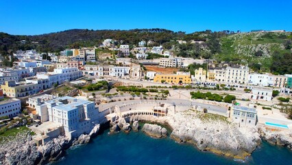 Obraz premium Santa Cesarea Terme - Italy, Apulia - Aerial view of the coastal town with houses and coastal road on the rocky shore
