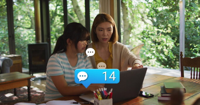 Image of social media icons with growing number over asian woman and her daughter using laptop