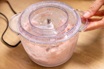Just ground meat mince in the glass bawl of the electrical chopper on the kitchen counter top....