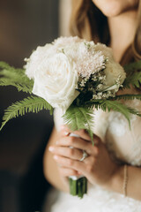 Beautiful bride holds bouquet. bouquet of white rosses in woman's hands