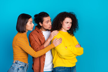 Young friends showcasing emotional dynamics and gestures on vibrant blue background portraying...