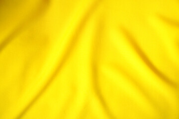 The yellow satin fabric is beautifully wavy.