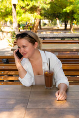 Pretty young girl wearing shorts and a white shirt in the summer park 