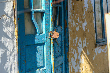 Rusty Lock on Weathered Wooden Door – Concept of Abandonment and Depopulation